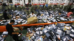 STO express crew deal with express packages at assembly line on November 12, 2014 in Wenzhou, Zhejiang province of China. Online shopping websites offered massive discounts on Singles&apos; Day (November 11) every year, which brings huge pressure to China&apos;s express delivery business during that day. Copyright ChinaFotoPress, Getty Images