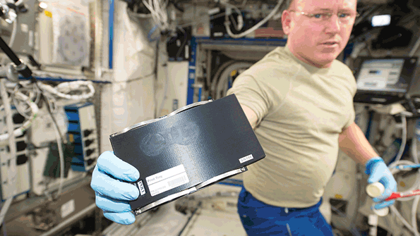 US astronaut Barry Wilmore holds a 3D coupon that was used with a 3D printer aboard the International Space Station to print a socket wrench NASA photo