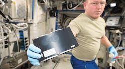 U.S. astronaut Barry Wilmore holds a 3-D coupon that was used with a 3-D printer aboard the International Space Station to print a socket wrench. (NASA photo)