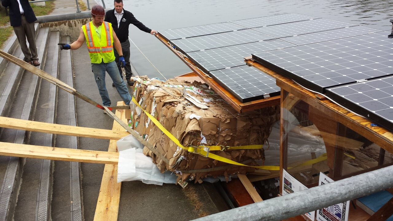 The bales of recycled cardboard emerge from the cargo hold of Solar Sal Each bale weighed about 1200 lbs