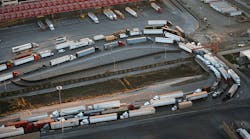 A line of cargo trucks crosses from the Mexican side of the border into the U.S. port of entry at Otay Mesa near San Diego, Calif. (Photo by John Moore/Getty Images)