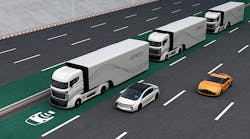 A platoon of autonomous hybrid trucks driving on a wireless charging lane.