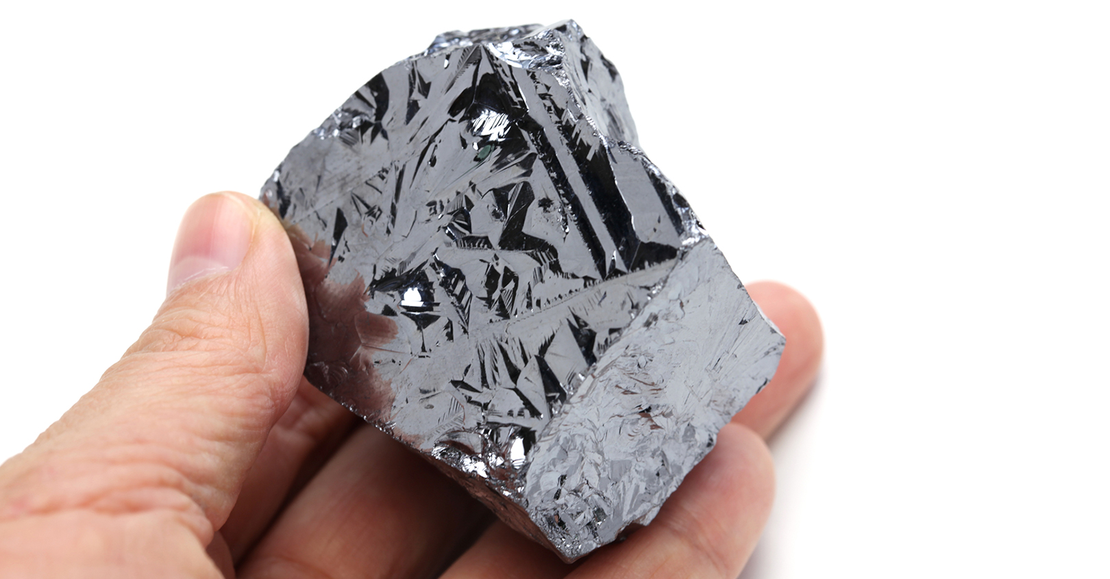 Hand holding polycrystalline silicon, aka polysilicon.